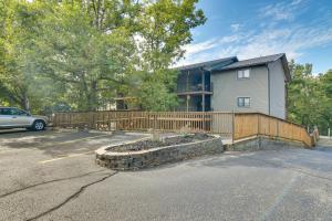 a house with a fence in a parking lot at 2 Mi to Silver Dollar City Cozy Condo with Balcony! in Branson West