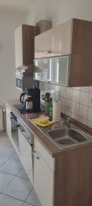 a kitchen with a sink and a counter top at FeWo Am Tummelplatz in Blankenburg