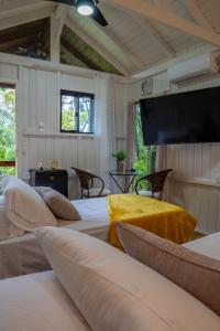 a room with two beds and a flat screen tv at Bulegreen Cabanas in Santo Amaro da Imperatriz