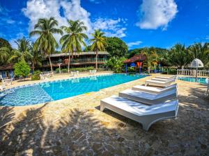 a swimming pool with lounge chairs and a resort at Tacarcuna Lodge in Capurganá