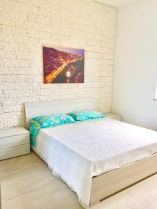 a bed in a room with a brick wall at casa vacanze lido riccio in Ortona