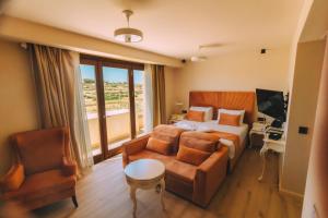 a hotel room with a bed and a couch at Santa Lucia Boutique Hotel in Santa Luċija