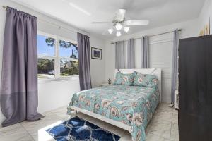 a bedroom with a bed and a ceiling fan at 4 Br Heated Pool Hot Tub Lanai Outdoor Gazebo in Marco Island +17 photos