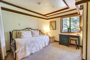 a bedroom with a bed and a desk and a window at Incline Village Condo with Balcony 1 Mi to Trail! in Incline Village