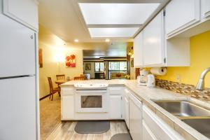 a kitchen with white cabinets and a sink at Incline Village Condo with Balcony 1 Mi to Trail! in Incline Village