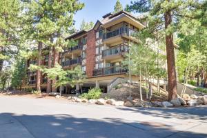 an apartment building with trees in front of a street at Incline Village Condo with Balcony 1 Mi to Trail! in Incline Village