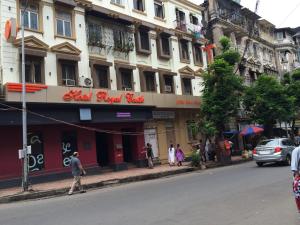a group of people standing outside of a building at Hotel Royal Castle in Mumbai