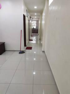 a hallway of a building with a white tile floor at ZMK STAY 