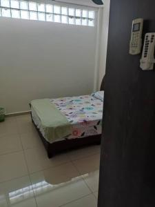 a small bed sitting in a room with a window at ZMK STAY 