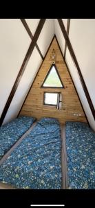 a small attic room with a window in a tent at Bungalow Gölçam in Denizli