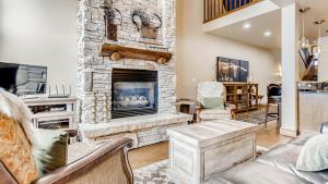 a living room with a stone fireplace at Pines 75 Townhome in Breckenridge