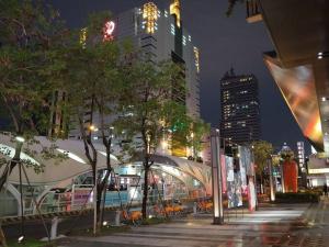 a city street at night with tall buildings at 台中晶華居 Fine House Taichung in Taichung