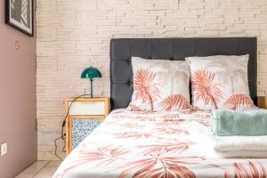 a bedroom with a bed with palm trees on it at Location Cosy Paris in Saint-Michel-sur-Orge