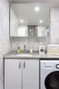 a kitchen with a washing machine and a sink at One and Only Brandnew Full Apartment in Istanbul