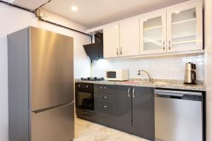 a kitchen with a stainless steel refrigerator and cabinets at One and Only Brandnew Full Apartment in Istanbul