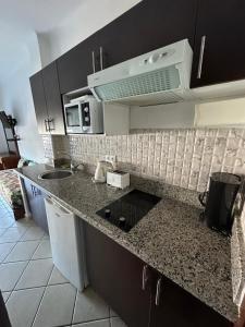 a kitchen with a sink and a counter top at Appart-Hotel cabo dream in Cabo Negro