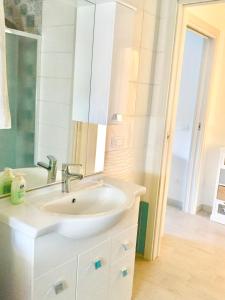 a bathroom with a sink and a mirror at casa vacanze lido riccio in Ortona
