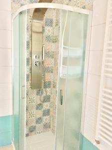 a shower with a glass door in a bathroom at casa vacanze lido riccio in Ortona