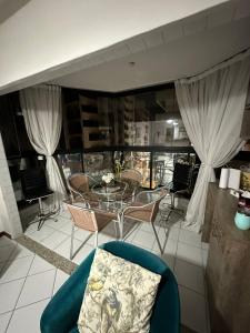 a room with a table and chairs and a dining room at Apartamento Areia Preta Guarapari in Guarapari +8 photos