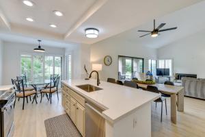 a kitchen and living room with a table and chairs at Quiet Palm Desert Condo Workspace and Pool Access! in Palm Desert