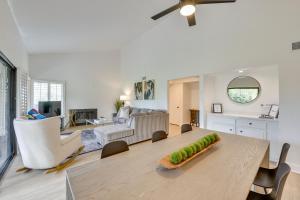 a dining room and living room with a large table at Quiet Palm Desert Condo Workspace and Pool Access! in Palm Desert