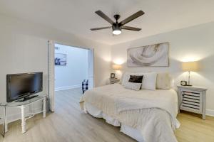 a bedroom with a bed and a flat screen tv at Quiet Palm Desert Condo Workspace and Pool Access! in Palm Desert +24 photos