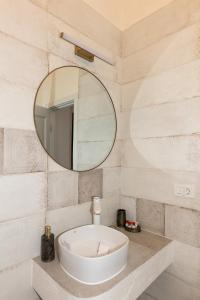 a bathroom with a white sink and a mirror at Conacul Buzdugan 