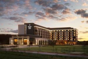 a building with a sign on the front of it at Delta Hotels by Marriott Dallas Southlake in Southlake