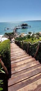 a wooden pathway leading to a beach with a pier at casa vacanze lido riccio in Ortona