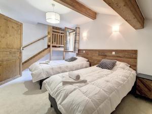 two beds in a room with white walls at Chalet Saint-Martin-de-Belleville-Les Menuires, 5 pièces, 10 personnes - FR-1-344-1186 in Praranger