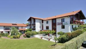 a hotel with a lawn in front of a building at Hotel & Appartements Gochoki in Bidart