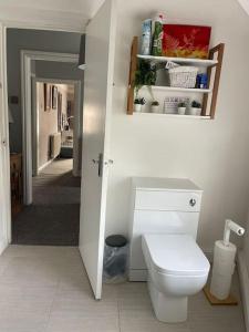 a bathroom with a toilet and a hallway at Rooms@ Remedy 2 bedroom (sleeps 5) apartment in Crossens