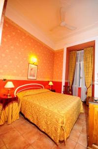 a bedroom with a yellow bed in a room at HOTEL MILAZZO in Rome