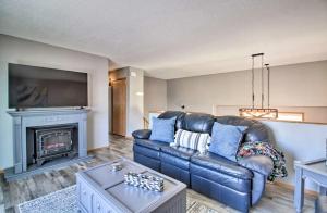 a living room with a leather couch and a fireplace at Welcoming West Fargo Retreat w Backyard in West Fargo