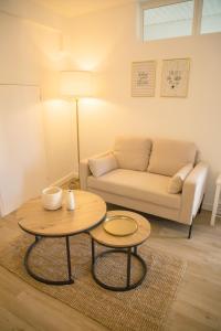 a living room with a couch and a table at Le Marais - Appart'Escale in Saint-Nazaire