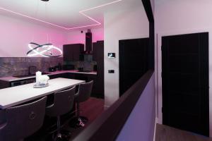 a kitchen with a white counter and pink walls at Hamilton Apartments in Leeds