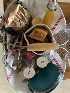 een mand gevuld met brood en andere items op een tafel bij Les Pensions du Joslin in Bouin