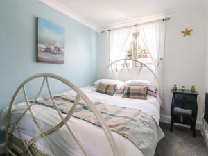 a bedroom with a bed with a metal frame at Resthaven in Harwich