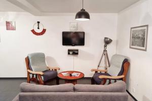 a living room with two chairs and a couch at GOOD HOME Chez Lulu, plage & centrale in Gravelines