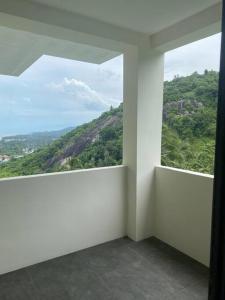 a room with a window with a view of a mountain at Villa Staring at the sea 3/4 ch jacuzzi piscine in Koh Samui 