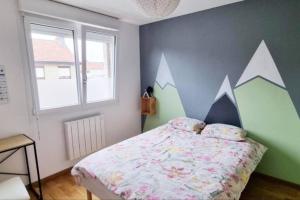 a bedroom with a bed with a flower pattern on it at GOOD HOME Chez Lulu, plage & centrale in Gravelines +20 photos