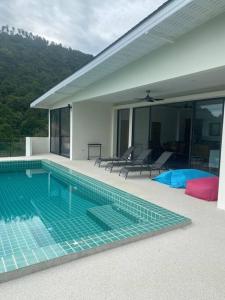 a swimming pool in the middle of a house at Villa Staring at the sea 3/4 ch jacuzzi piscine in Koh Samui