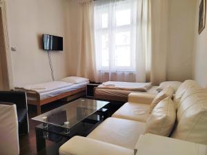 a living room with a couch and a table at Tower Apartments in Prague