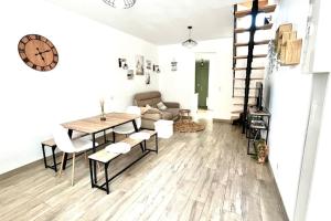 a living room with a table and a couch at L'échappée MERs- Maison 3 chambres au Centre 500m de la plage in Mers-les-Bains