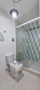 a bathroom with a toilet and a glass shower at Apto Varandas no andar 38 ,abaixo do SampaSKY in Sao Paulo