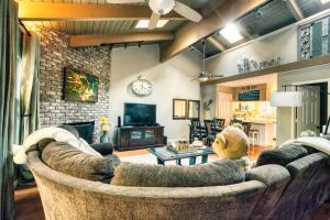 a living room with a large couch and a fireplace at Tahoe Condo about 1 Mi to Diamond Peak Ski Resort! in Incline Village