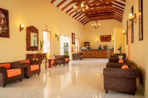 a lobby with couches and chairs in a room at Hotel Agustos Urubamba in Urubamba
