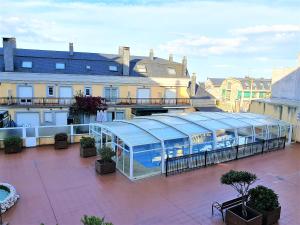 a glass greenhouse on top of a building at Apartamentos SOL Y PLAYA Foz in Foz