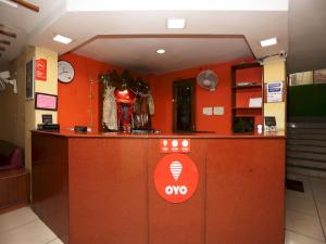 an office with an orange wall with a reception counter at Hotel Centre Point in Rānchī