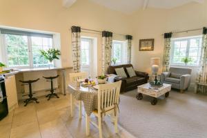 a living room with a table and a couch at Cae Mab Dafydd in Llanfairfechan